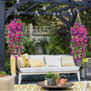 Artificial hanging silk morning glory flowers in vibrant pink and purple cascade over a wooden porch setting