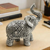 Silver resin elephant sculpture with intricate detailing, displayed on a wooden surface.