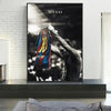 A canvas print featuring a dramatic black and white photo of Lionel Messi celebrating with the soccer ball.