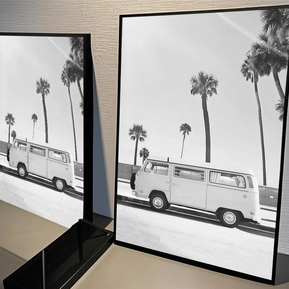 Black and white landscape poster featuring a white van driving past palm trees on a road.