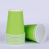 A stack of bright lime green disposable cups with white rims.