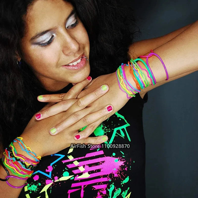 A woman wearing a set of glow-in-the-dark silicone bracelets on her wrist.