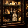 A display cabinet featuring a resin statue of a gothic skeleton bride and groom figurine.