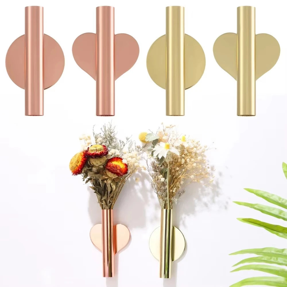 Modern wall-mounted flower vase in rose gold and gold finishes displayed against a white background.