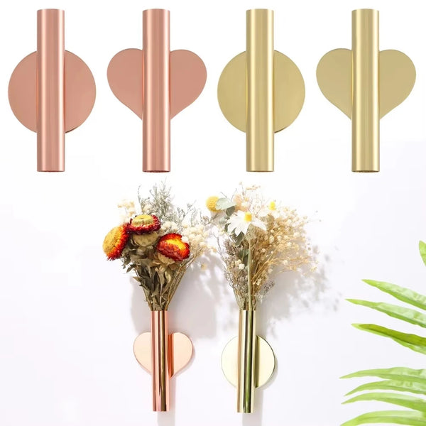 Modern wall-mounted flower vase in rose gold and gold finishes displayed against a white background.