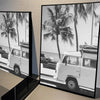 Black and white photograph of a palm tree beach landscape featuring vintage white vans.