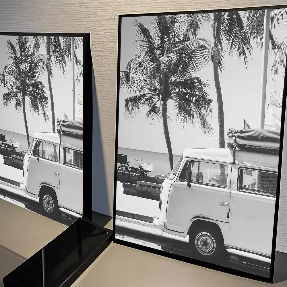 Black and white photograph of a palm tree beach landscape featuring vintage white vans.