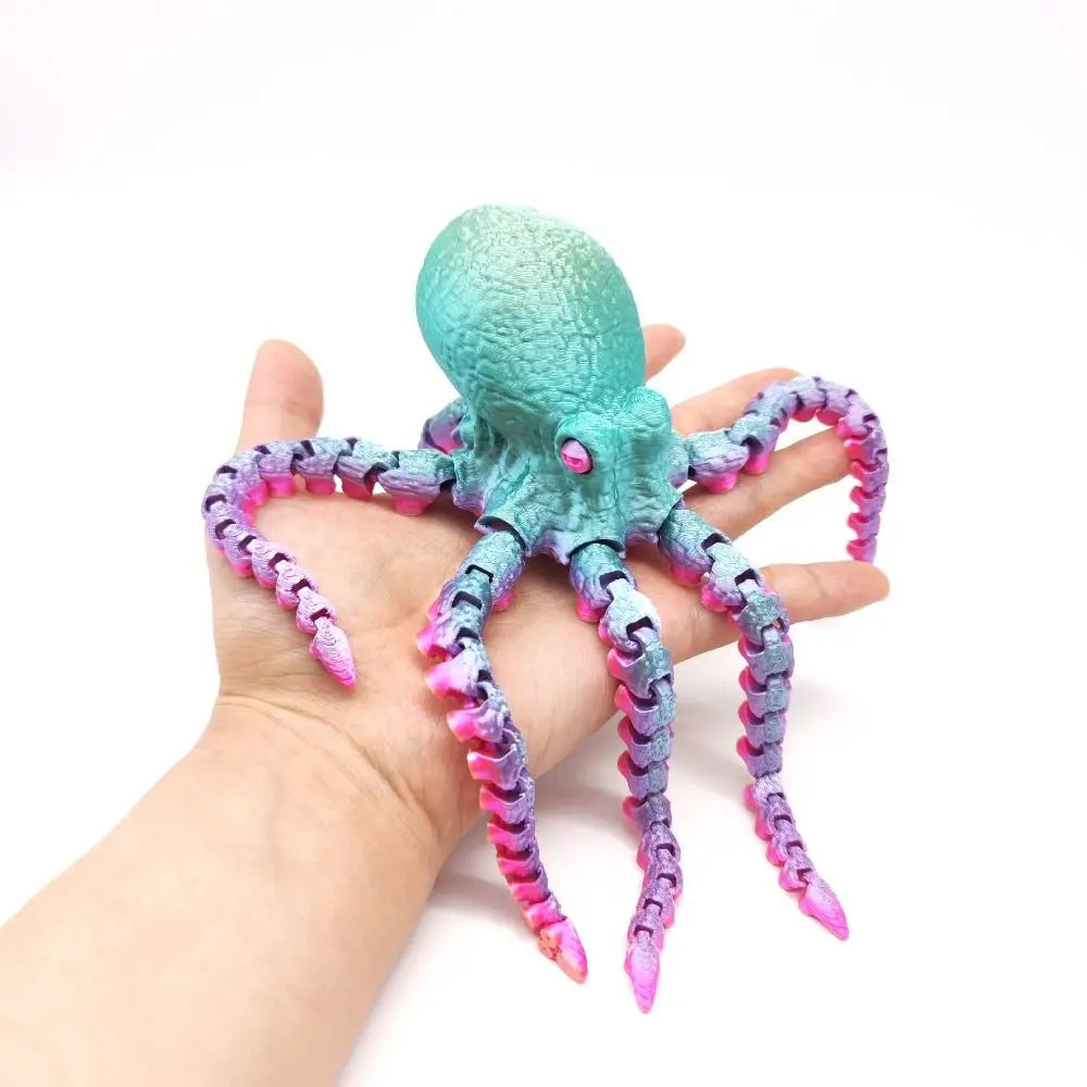 A hand holds a teal and purple articulated 3D printed octopus figurine with eight tentacles.