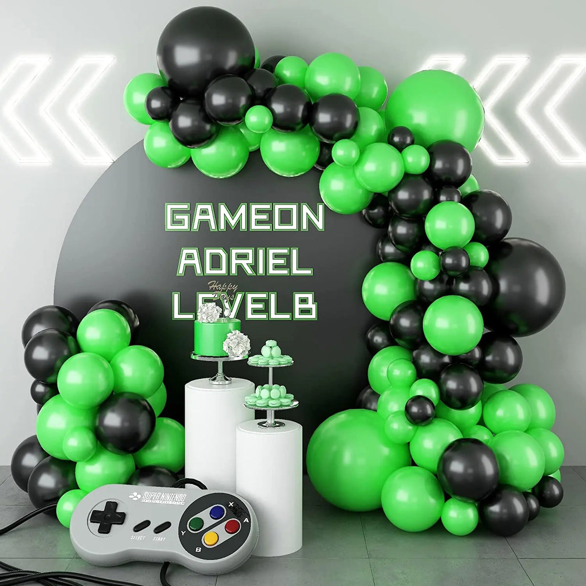 A balloon garland arch kit featuring black and green balloons with silver starburst accents and a controller.