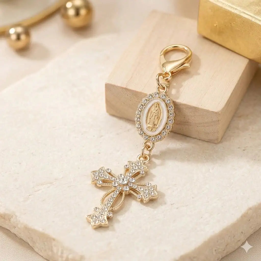 Gold pearl rhinestone cross keychain charm with a round medallion on a light background