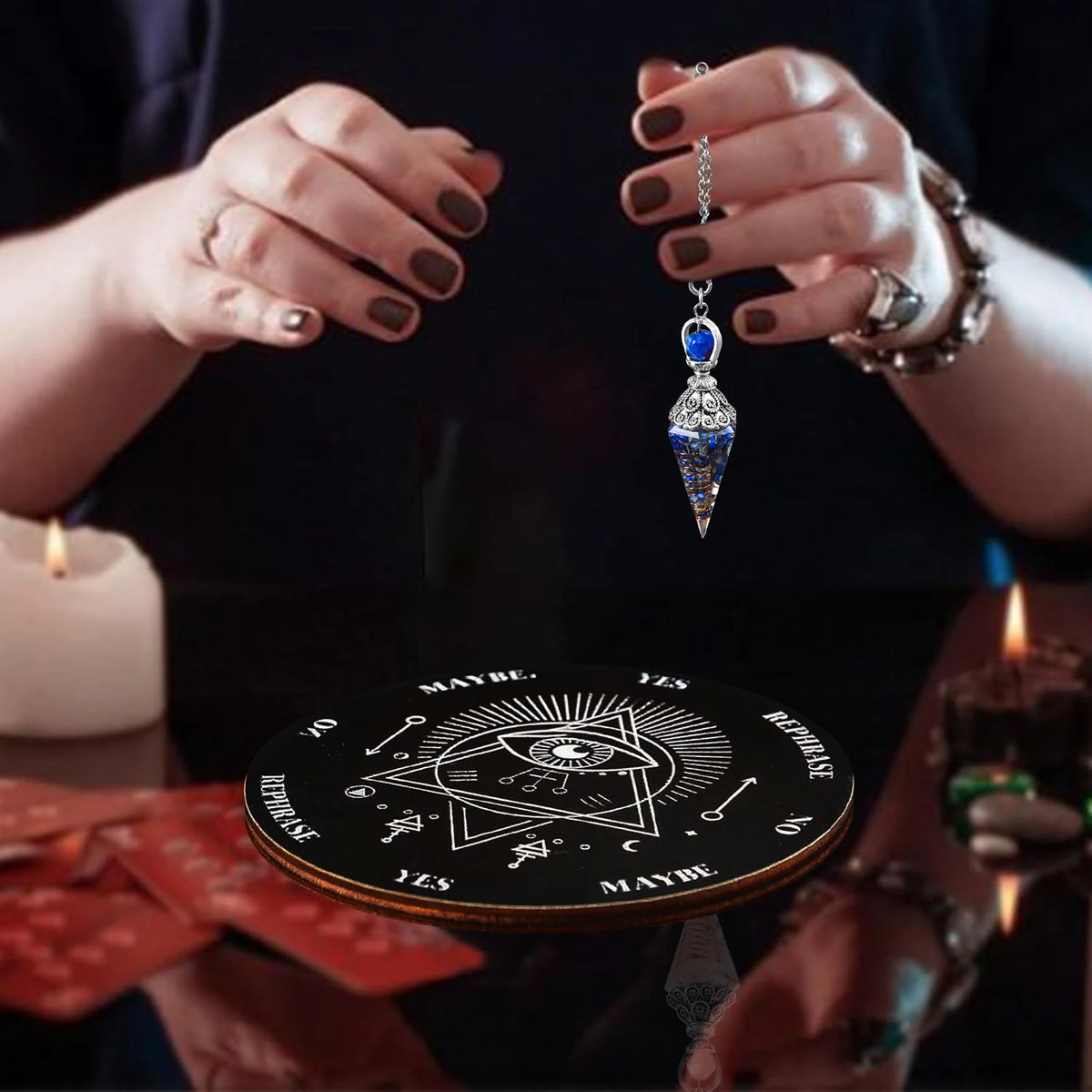 Hands holding a crystal pendulum over a wooden divination board with various symbols.