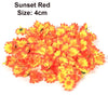 A pile of bright orange and yellow artificial sunflower and daisy heads for decoration.
