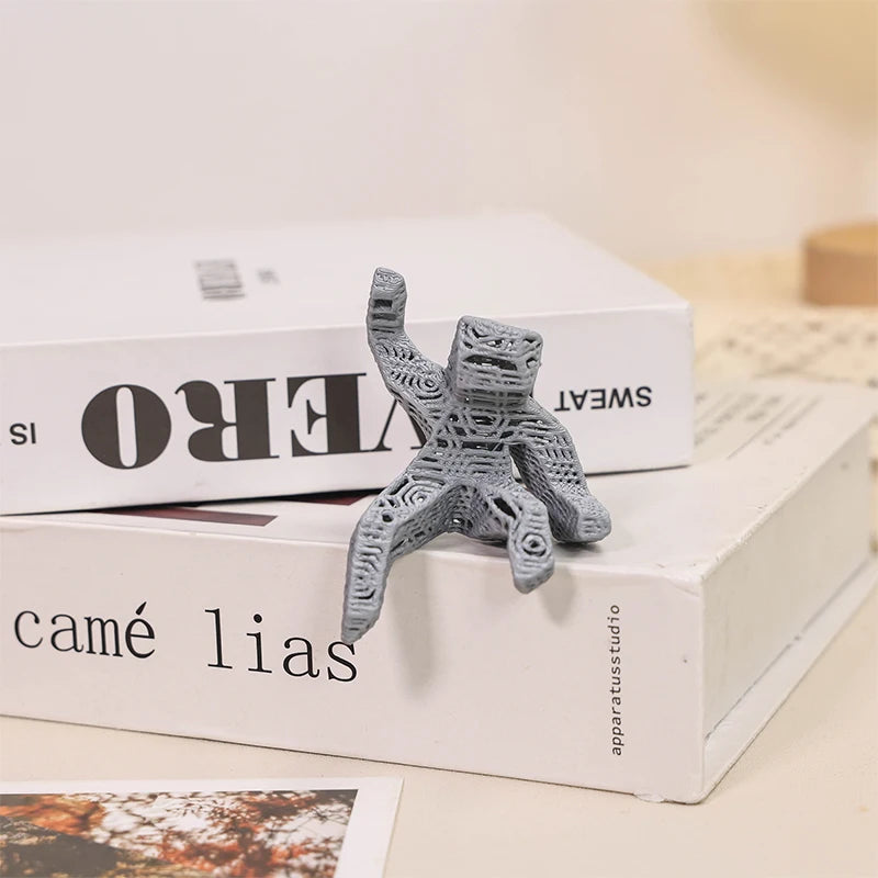 A gray collectible figurine of Rocky and Grace is displayed on white boxes.