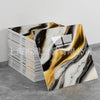 A stack of faux marble 3D self-adhesive wall tiles featuring black, white, and gold veining.