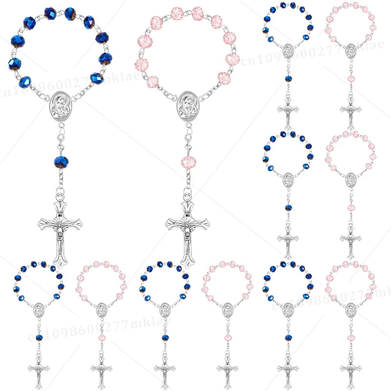 Assorted mini baptism rosary favors with cross necklaces featuring blue and pink beads.