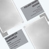 Close-up view of two silver metal tin signs demonstrating folded edges design and reinforced hardness features.