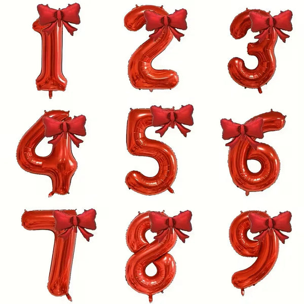 A set of large, shiny red foil number balloons shaped like 1 through 9 with matching bows.