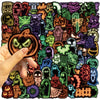 A hand holds a glowing pumpkin-themed sticker design featuring various spooky and Halloween-themed graphics.