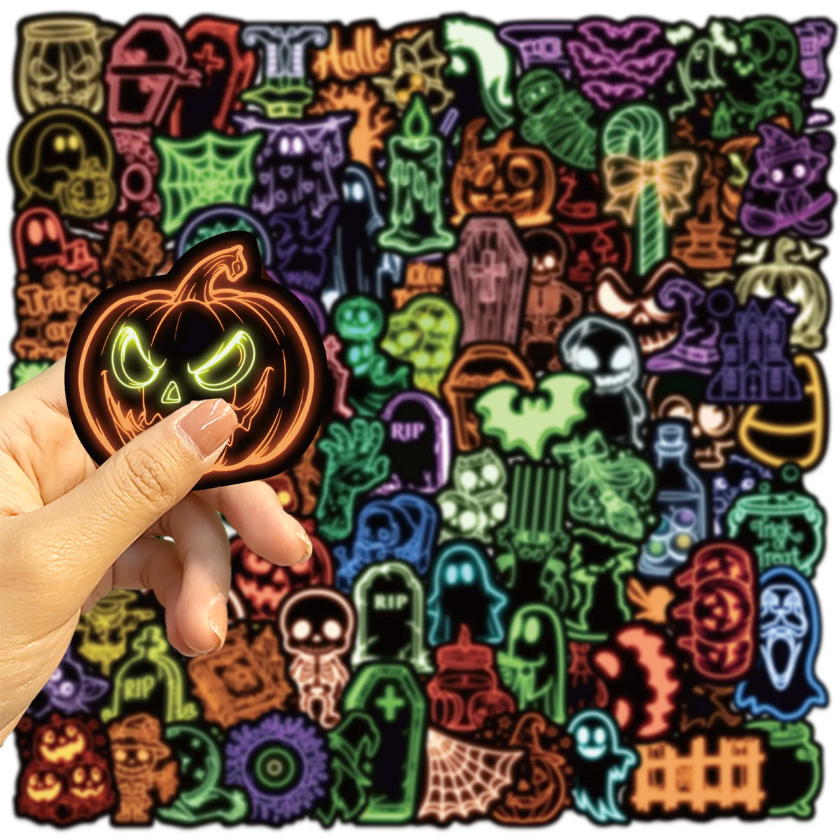 A hand holds a glowing pumpkin-themed sticker design featuring various spooky and Halloween-themed graphics.