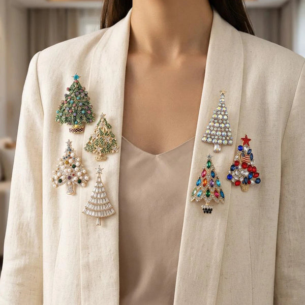 A beige blazer features several sparkling rhinestone Christmas tree brooches pinned on the lapel.