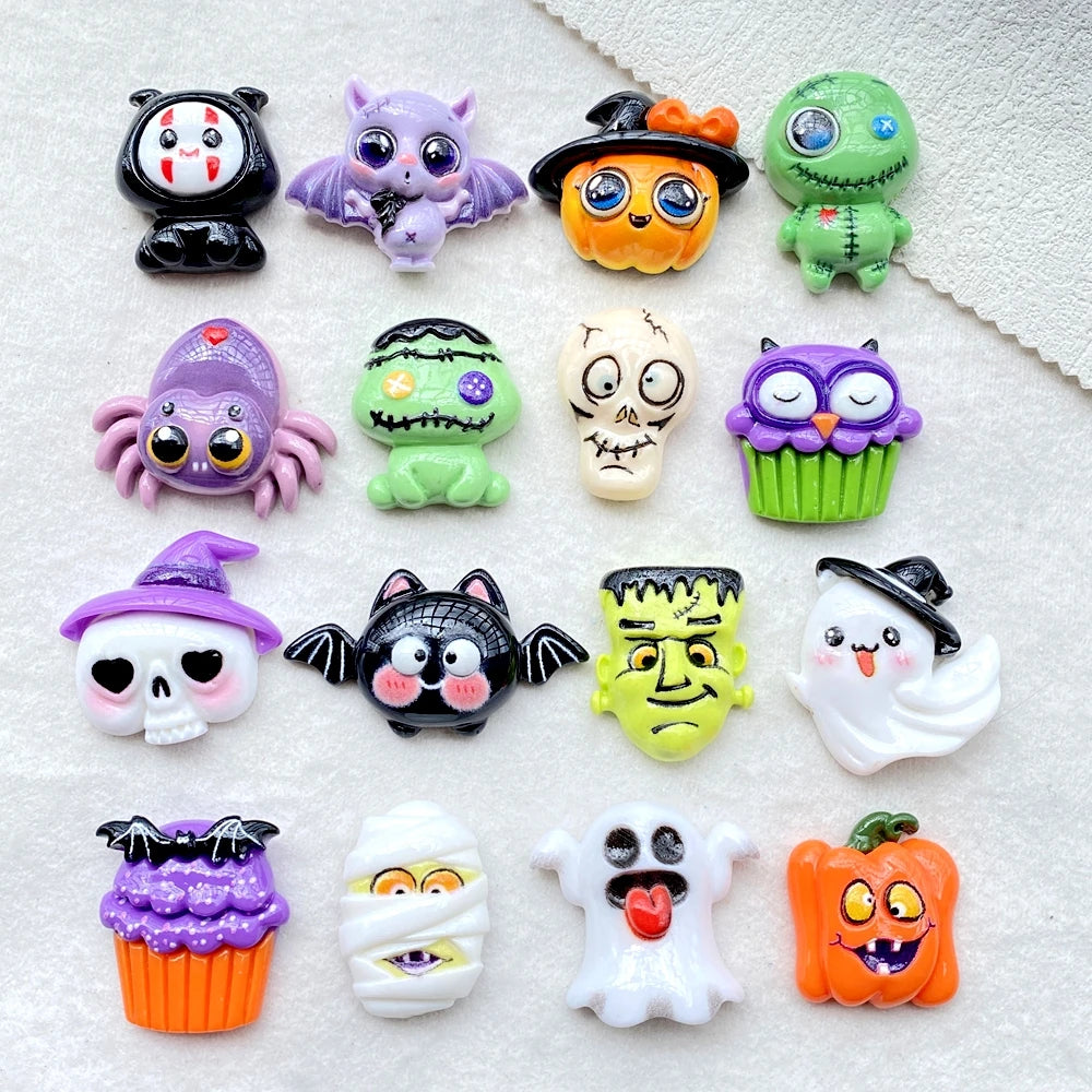 A collection of Halloween resin charms featuring skulls, bats, owls, and pumpkins in various colors like purple, green, black