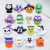 A collection of Halloween resin charms featuring skulls, bats, owls, and pumpkins in various colors like purple, green, black