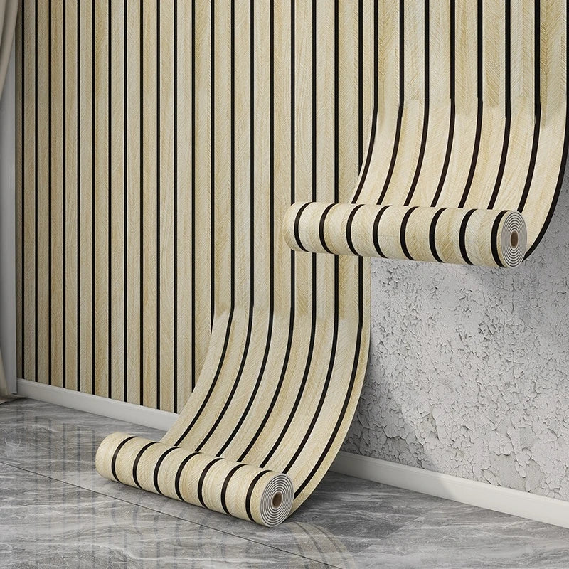 A roll of self-adhesive wood grain wallpaper featuring vertical stripes in beige and black tones mounted on a wall.