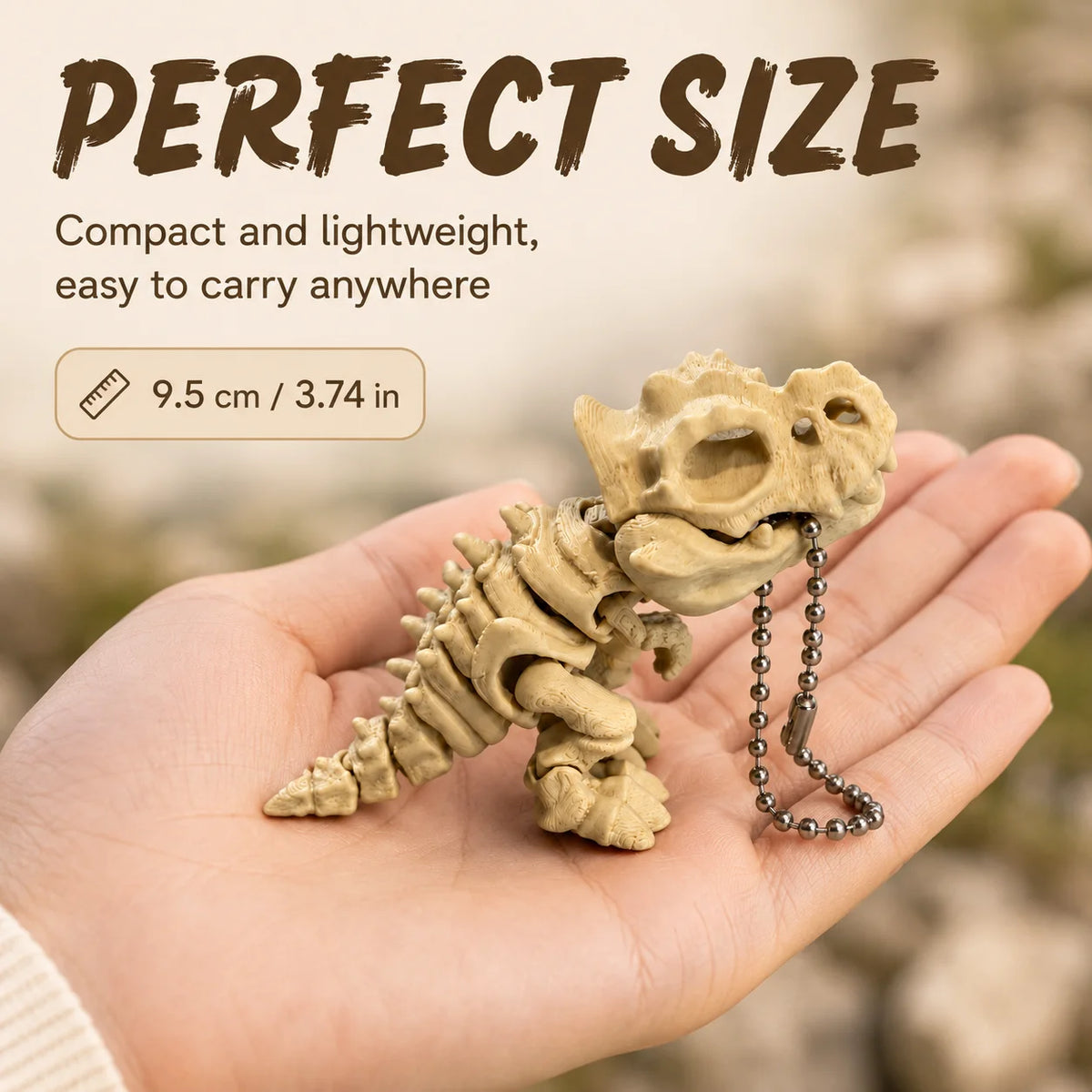 A hand holds a small, light beige 3D printed T-Rex skeleton model with articulated joints.