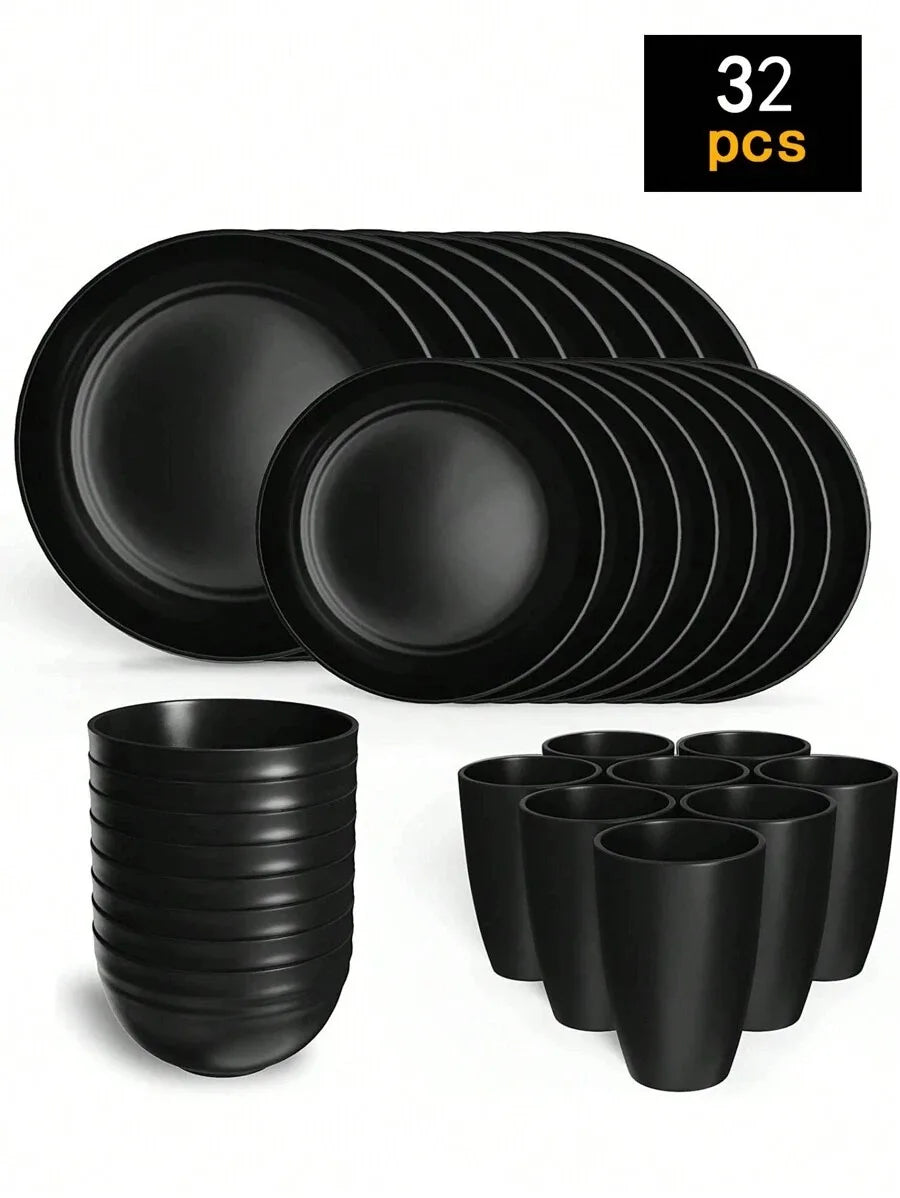 A set of 32 black reusable plastic tableware items including plates and cups.