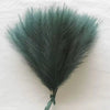 A bouquet of artificial dusty blue-green pampas grass used for boho home decor.