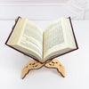 An open book with pages of text resting on an elegant wooden stand.