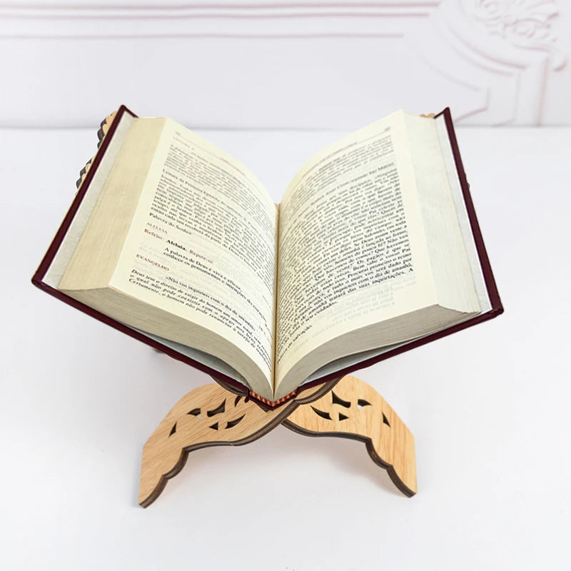 An open book with pages of text resting on an elegant wooden stand.