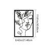 Black line art silhouette of a woman's face with leafy vines on a rectangular metal wall art print