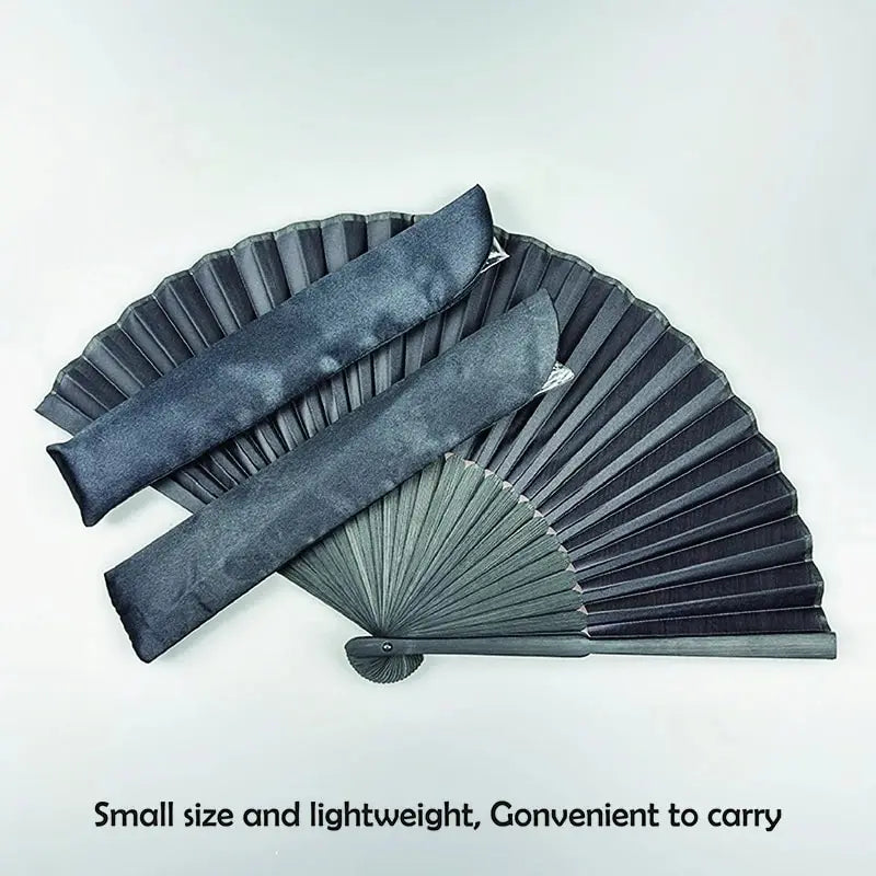 A black folding hand fan with a bamboo frame shown in a fan shape.