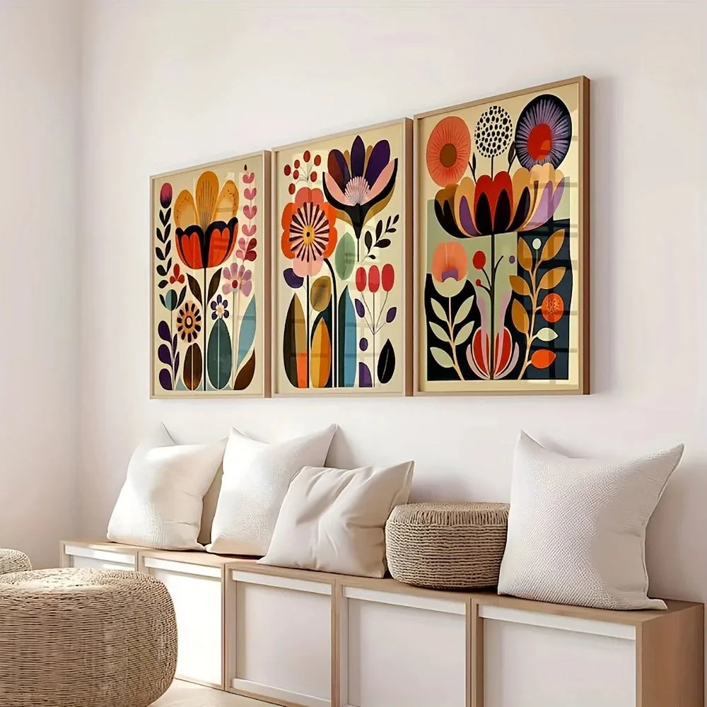 A set of three framed floral canvas prints featuring colorful Scandinavian folk art designs on a white wall.