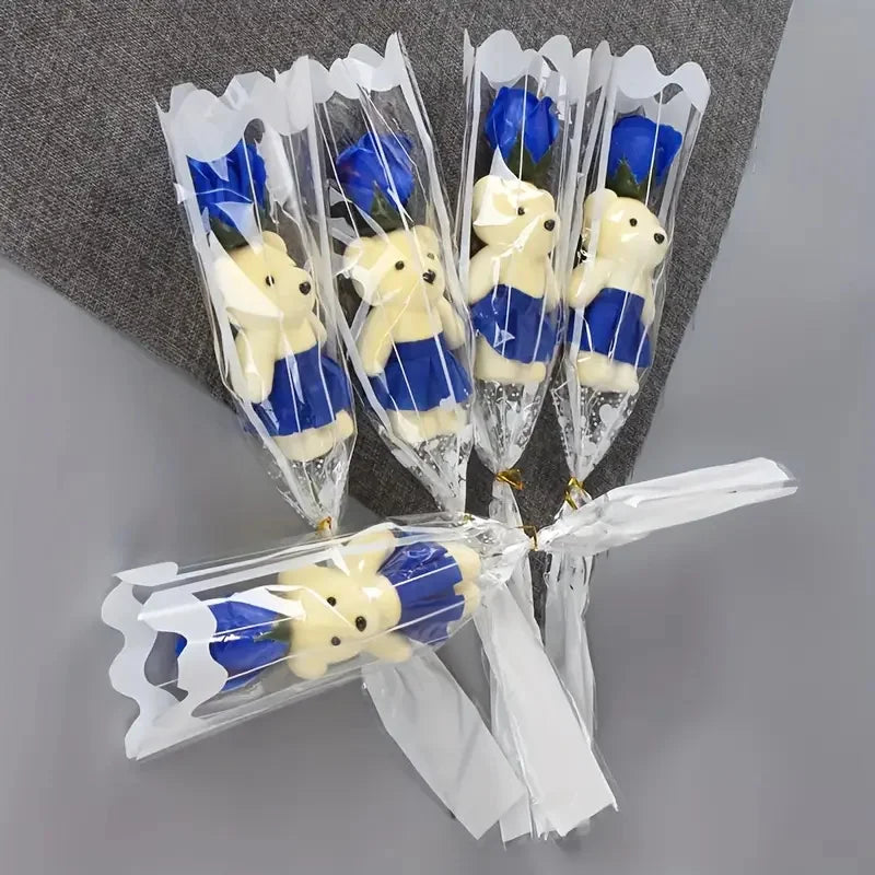 A bouquet of artificial rose soap featuring yellow and blue bear-shaped soaps wrapped in clear plastic.