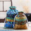 A set of vintage cotton drawstring gift pouches featuring intricate blue, green, and gold patterned fabric.
