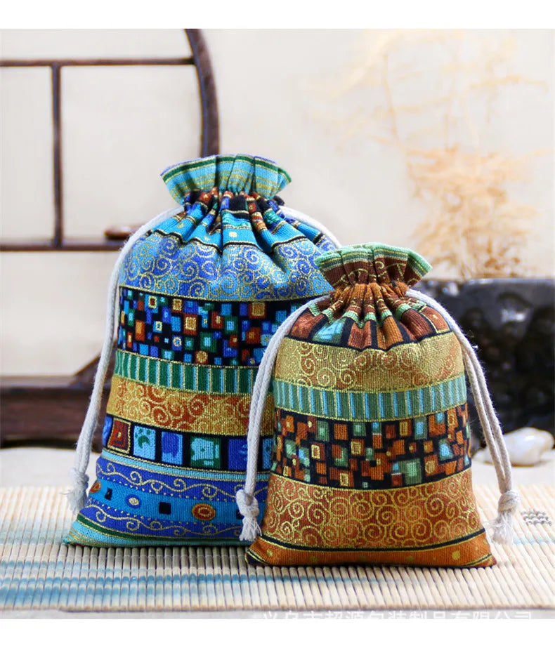 A set of vintage cotton drawstring gift pouches featuring intricate blue, green, and gold patterned fabric.