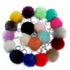 A collection of colorful faux fur pom pom keychains attached to silver chains.