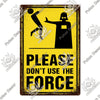 A vintage warning metal sign with a black silhouette of a figure and yellow text that reads Please Don't Use The Force