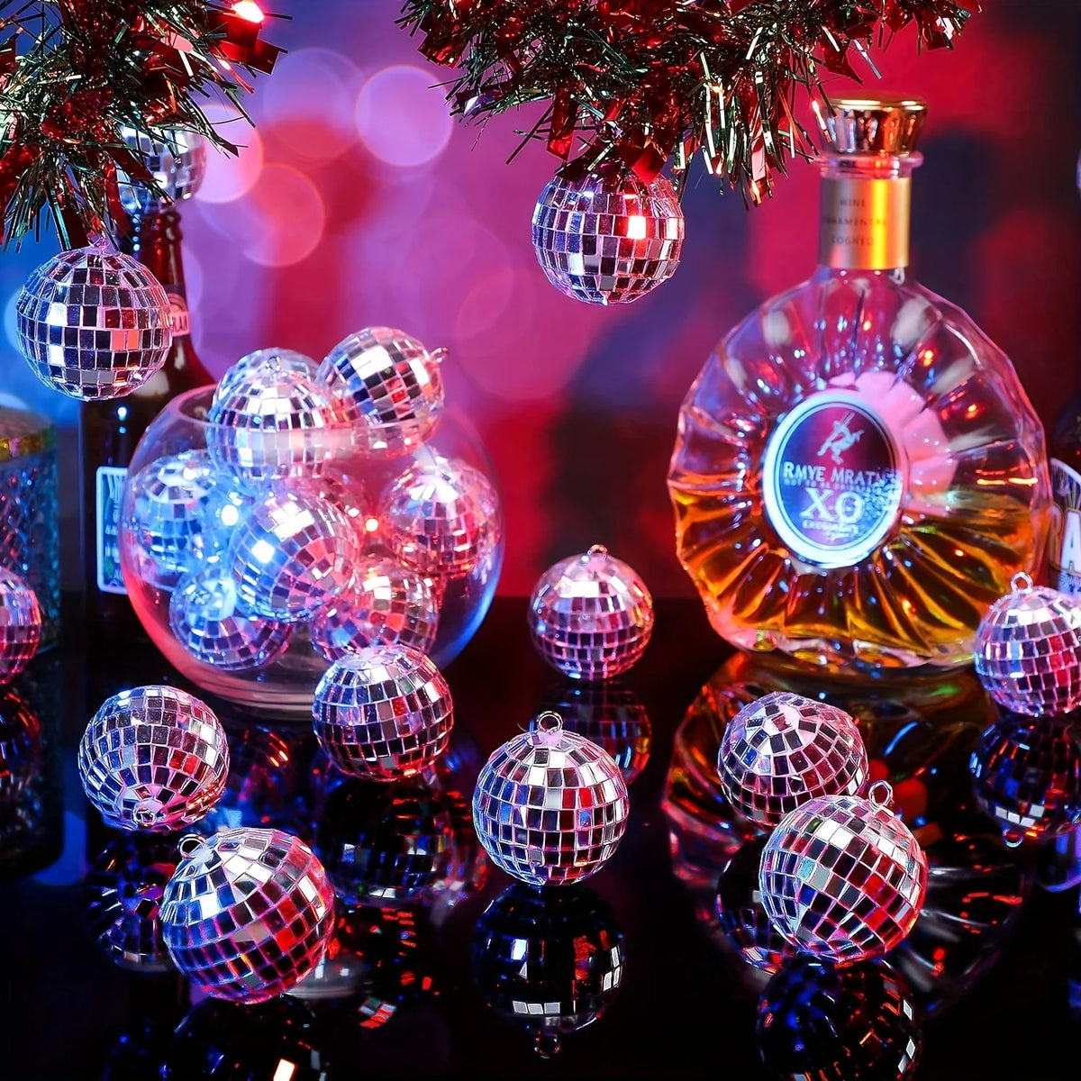 A close-up of a set of ten mirrored disco ball ornaments reflecting light on a dark surface.