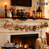 A decorative Halloween flag set featuring wooden pumpkins, ghosts, and moons displayed on a fireplace mantel.