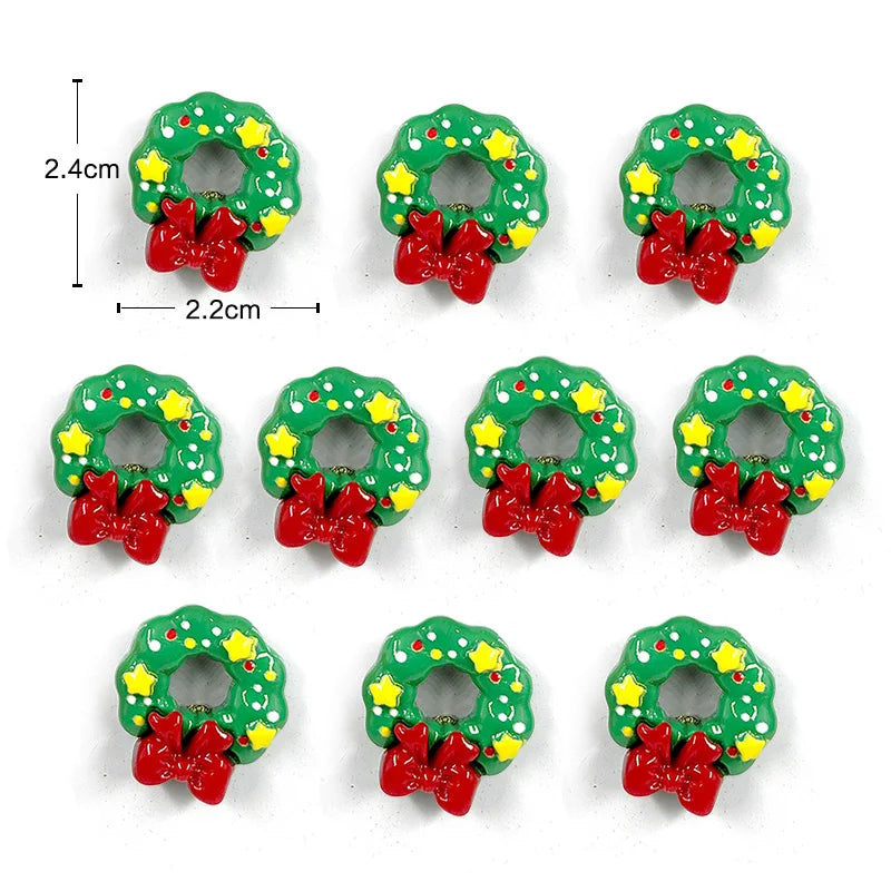 Un juego de imanes navideños en forma de corona verde y roja para nevera con un lazo colgante.