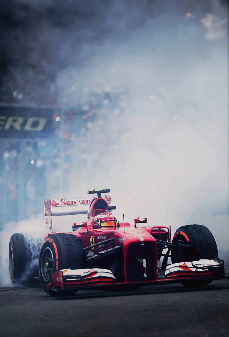 A red Formula 1 race car is kicking up smoke on the track during a race.