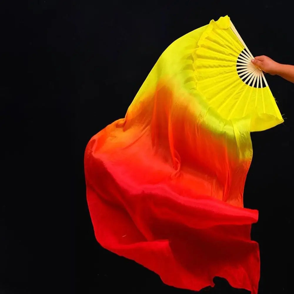 A vibrant silk ribbon dance fan showing a gradient of yellow, orange, and red against a black background.