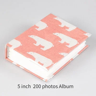 A pink memory album featuring a pattern of white cartoon pandas.