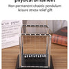 A silver Newton's cradle ornament with three glass balls on a black base.