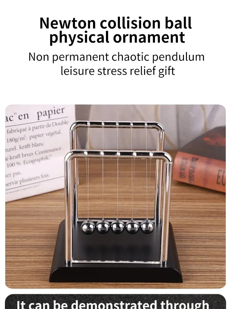 A silver Newton's cradle ornament with three glass balls on a black base.