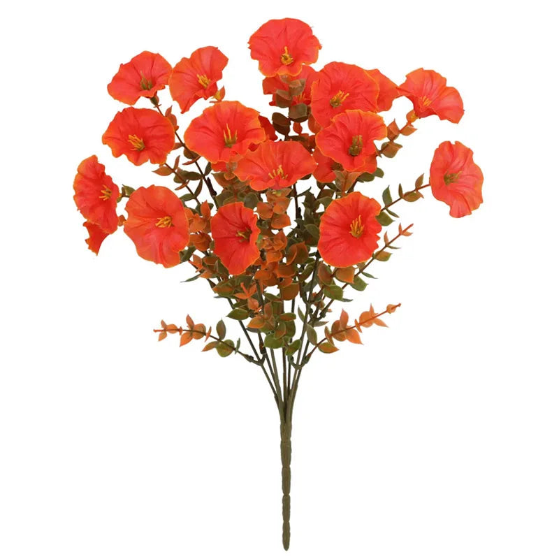A spray of vibrant artificial pansy flowers in shades of orange and red on a brown stem.