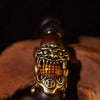 A close-up of a handcrafted Thunder-Wood Pixiu bracelet featuring gold-toned metalwork and semi-jade beads.